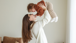 Woman holding a kid up. 