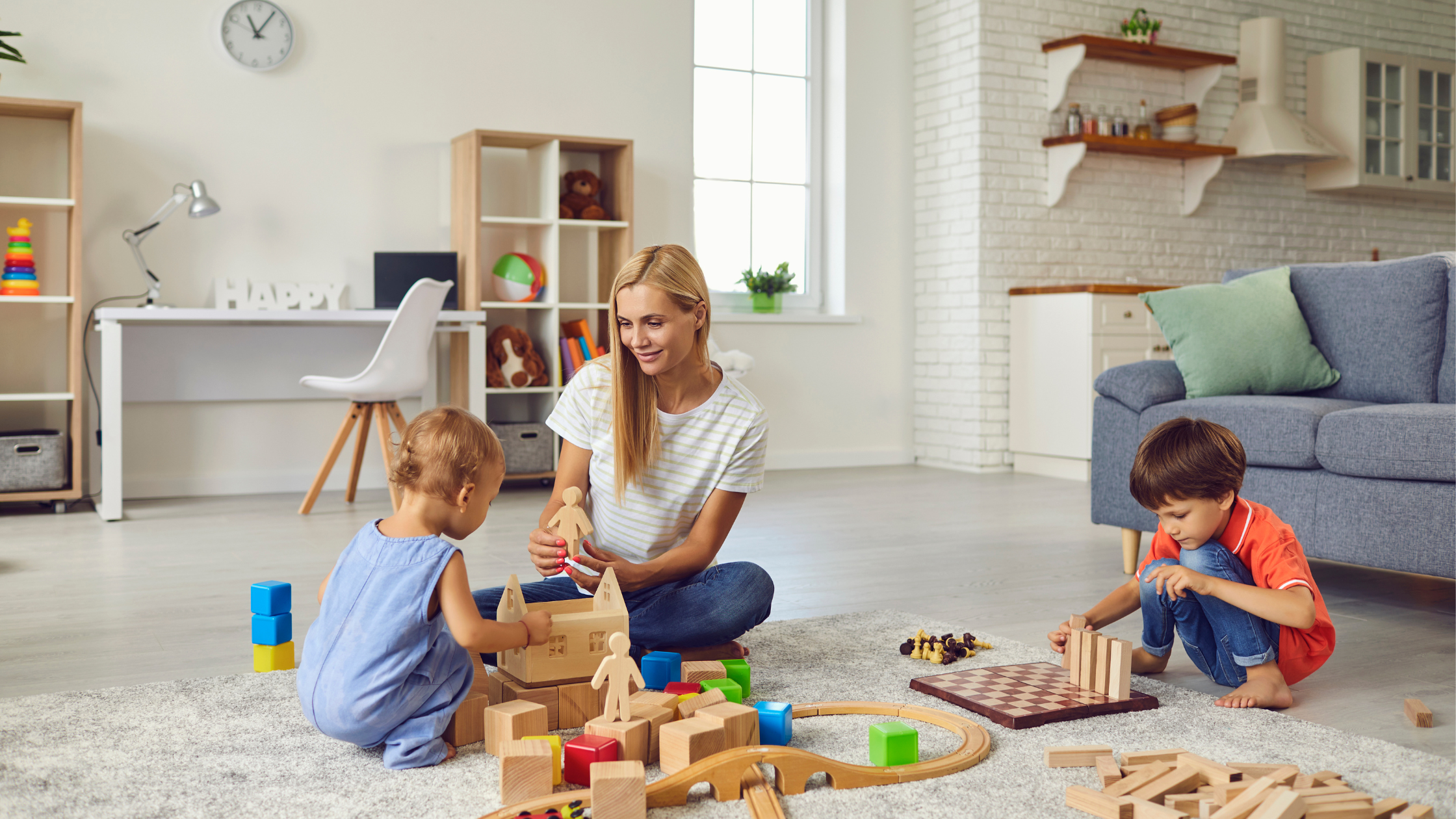 A woman is playing with two kids.